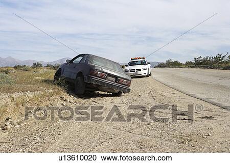 Police car near abandoned car on roadside View Large Photo Image Stock Image - Police car near abandoned car on roadside. Fotosearch