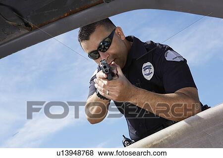 Police officer aiming gun through car window View Large Photo Image Stock Photo - Police officer aiming gun through car window. Fotosearch
