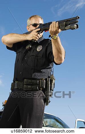 Stock Image - Police Officer Aiming Shotgun. Fotosearch