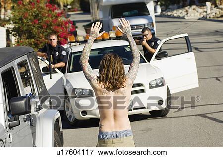 Police Officer Arresting Young Man View Large Photo Image Stock Photo - Police Officer Arresting Young Man. Fotosearch
