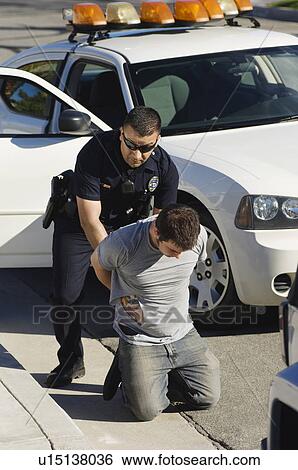 Police Officer Arresting Young Man View Large Photo Image Stock Photograph - Police Officer Arresting Young Man. Fotosearch