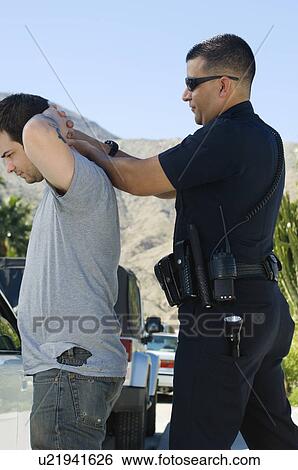 Police Officer Arresting Young Man View Large Photo Image Stock Photograph - Police Officer Arresting Young Man. Fotosearch