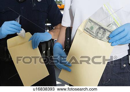 Police Officer Putting Money in Evidence Envelope View Large Photo Image Stock Image - Police Officer Putting Money in Evidence Envelope. Fotosearch