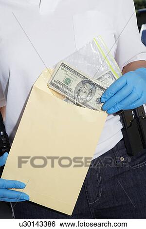 Police Officer Putting Money in Evidence Envelope View Large Photo Image Stock Photograph - Police Officer Putting Money in Evidence Envelope. Fotosearch