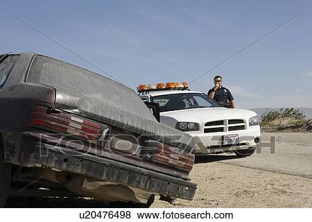 Police officer talking on CB radio on roadside View Large Photo Image Stock Photo - Police officer talking on CB radio on roadside. Fotosearch