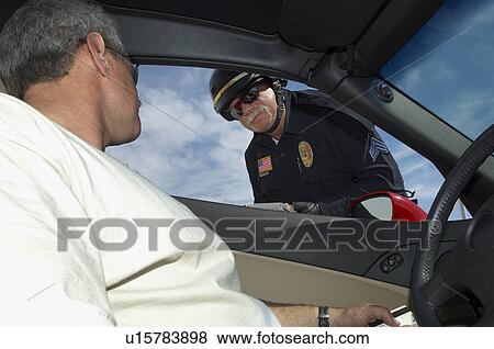 Stock Photo - Police officer talking with driver, view from car. Fotosearch