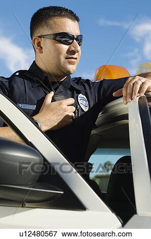 Stock Photo - Police Officer Using Two-Way Radio. Fotosearch