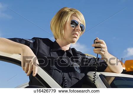 Stock Photo - Police Officer Using Two-Way Radio. Fotosearch