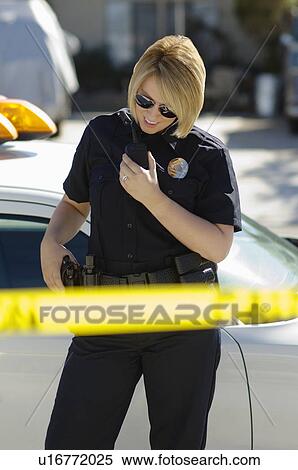 Stock Photography - Police Officer Using Two-Way Radio. Fotosearch