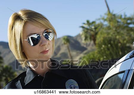 Stock Image - Police Officer Wearing Sunglasses. Fotosearch
