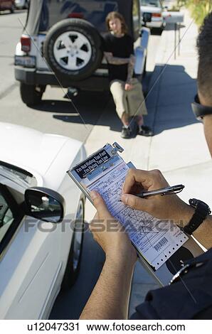 Stock Image - Police Officer Writing Ticket. Fotosearch