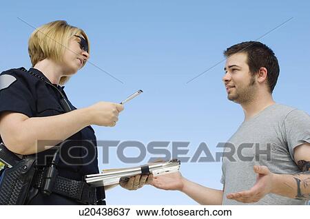 Stock Photo - Police Officer Writing Ticket. Fotosearch