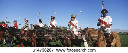 Stock Photo - Polo team on horseback in field. Fotosearch