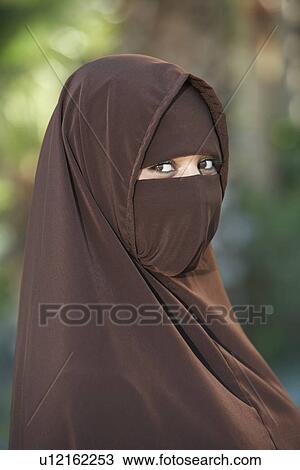 Stock Image - Portarit of young woman in brown niqab. Fotosearch