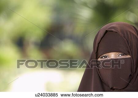 Stock Photography - Portarit of young woman in brown niqab. Fotosearch