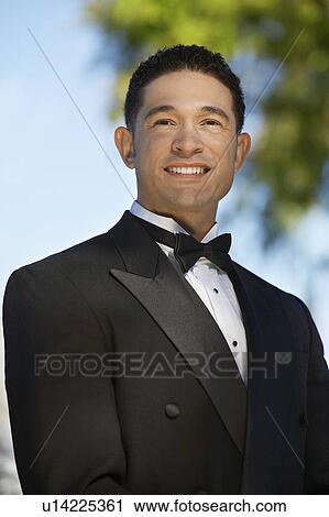 Stock Image - Portrait of boy (13-15) in tuxedo at Quinceanera. Fotosearch