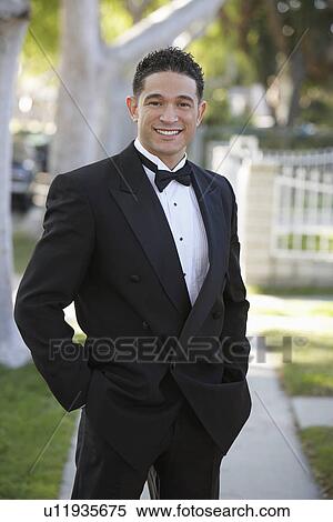 Stock Photography - Portrait of boy (13-15) in tuxedo at Quinceanera. Fotosearch