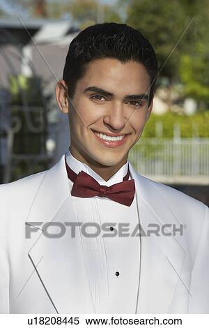 Stock Photography - Portrait of boy (13-15) in tuxedo at Quinceanera. Fotosearch