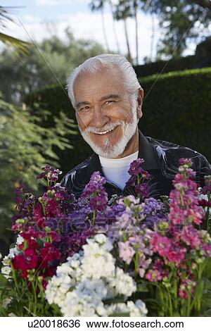 Stock Photograph - Portrait of elderly man in garden. Fotosearch