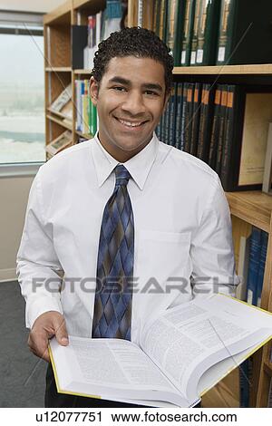 Portrait of man with book in library View Large Photo Image Stock Image - Portrait of man with book in library. Fotosearch