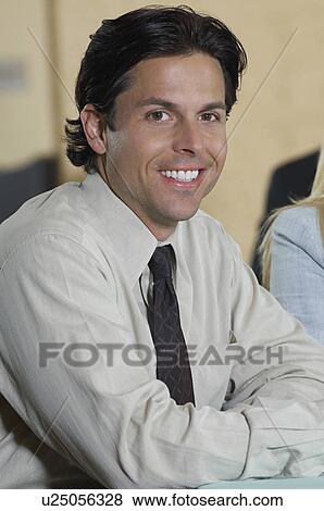Stock Photo - Portrait of mid adult businessman smiling. Fotosearch