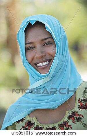 Stock Photography - Portrait of muslim woman in blue headscarf, smiling. Fotosearch
