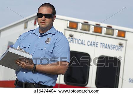 Picture - Portrait of paramedic in front of ambulance. Fotosearch