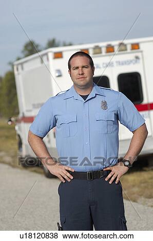 Stock Photo - Portrait of paramedic in front of ambulance. Fotosearch