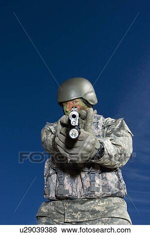 Stock Photo - Portrait of soldier aiming to camera. Fotosearch