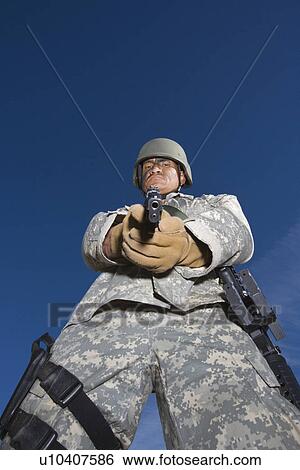 Stock Photograph - Portrait of soldier aiming to camera. Fotosearch