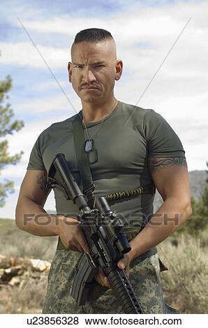 Stock Photo - Portrait of soldier with machine gun. Fotosearch