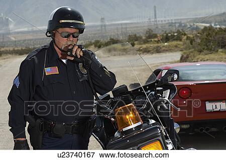 Portrait of traffic cop using radio View Large Photo Image Stock Photo - Portrait of traffic cop using radio. Fotosearch