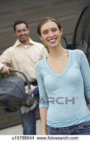 Picture - Portrait of woman, man in background. Fotosearch