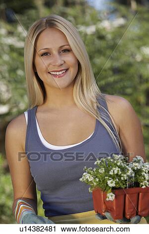 Portrait of woman with flowers in garden View Large Photo Image Stock Image - Portrait of woman with flowers in garden. Fotosearch