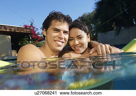 Portrait of young couple in swimming pool View Large Photo Image Stock Image - Portrait of young couple in swimming pool. Fotosearch