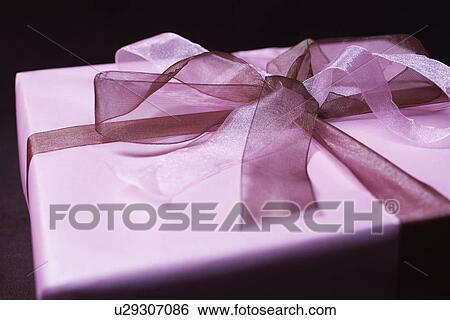 Present with ribbon, close-up View Large Photo Image Stock Photograph - Present with ribbon, close-up. Fotosearch