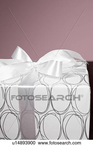 Stock Image - Present wrapped with silver ribbon. Fotosearch