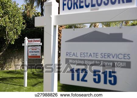 Stock Photograph - Real Estate Signs at Foreclosed Property. Fotosearch
