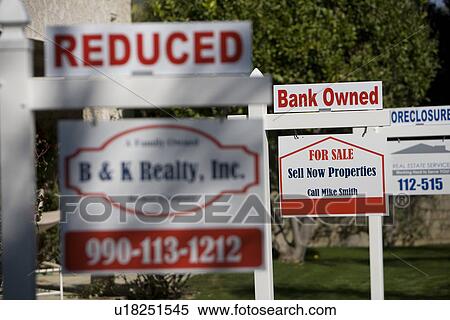 Stock Photography - Real Estate Signs at Foreclosed Property. Fotosearch
