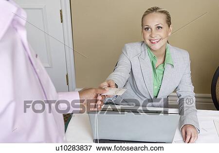 Receptionist distributing name tags View Large Photo Image Stock Photo - Receptionist distributing name tags. Fotosearch