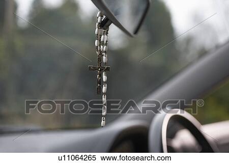 Stock Photography - Rosary beads hanging in car. Fotosearch