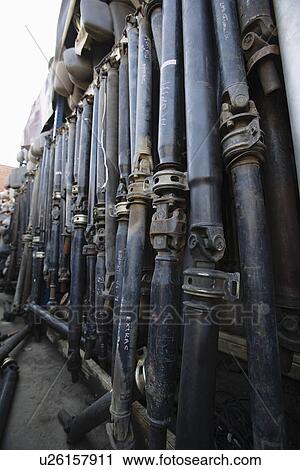 Stock Image - Row of car parts in junkyard. Fotosearch
