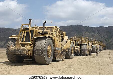Row of trucks at landfill site View Large Photo Image Stock Image - Row of trucks at landfill site. Fotosearch