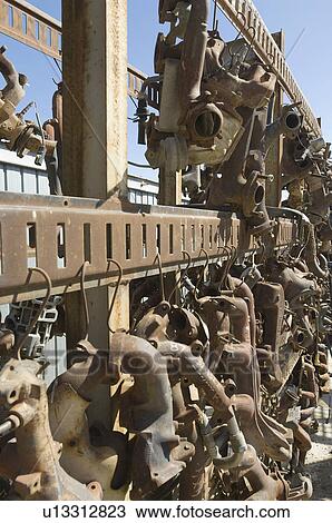 Stock Image - Rusty car parts on rack. Fotosearch