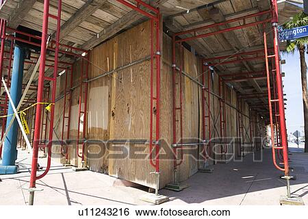 Stock Photograph - Scaffolding Around Boarded Up Property. Fotosearch