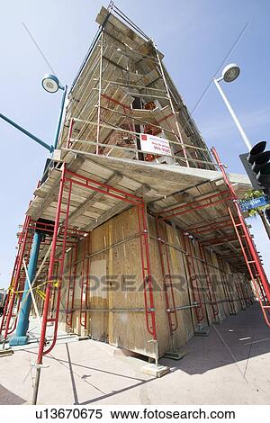 Stock Photography - Scaffolding Around Boarded Up Property. Fotosearch