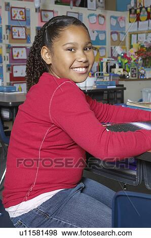 School girl sitting in classroom, portrait View Large Photo Image Stock Photo - School girl sitting in classroom, portrait. Fotosearch