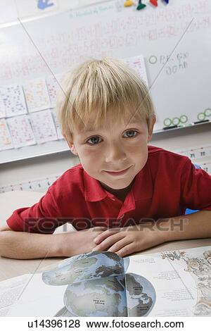 Stock Photo - Schoolboy Reading a Geography Book. Fotosearch