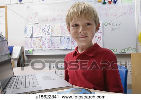 Stock Image - Schoolboy Using a Laptop. Fotosearch