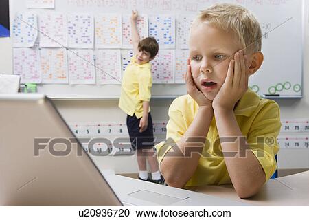 Stock Image - Schoolboy Using a Laptop. Fotosearch